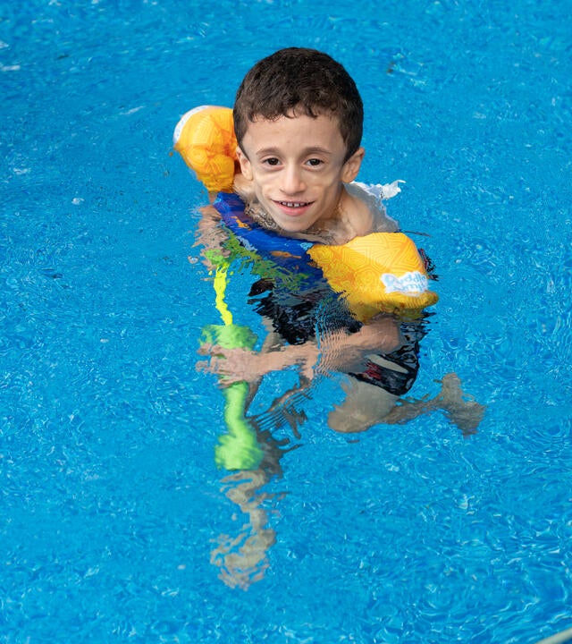 Wish kid Julian in swimming pool