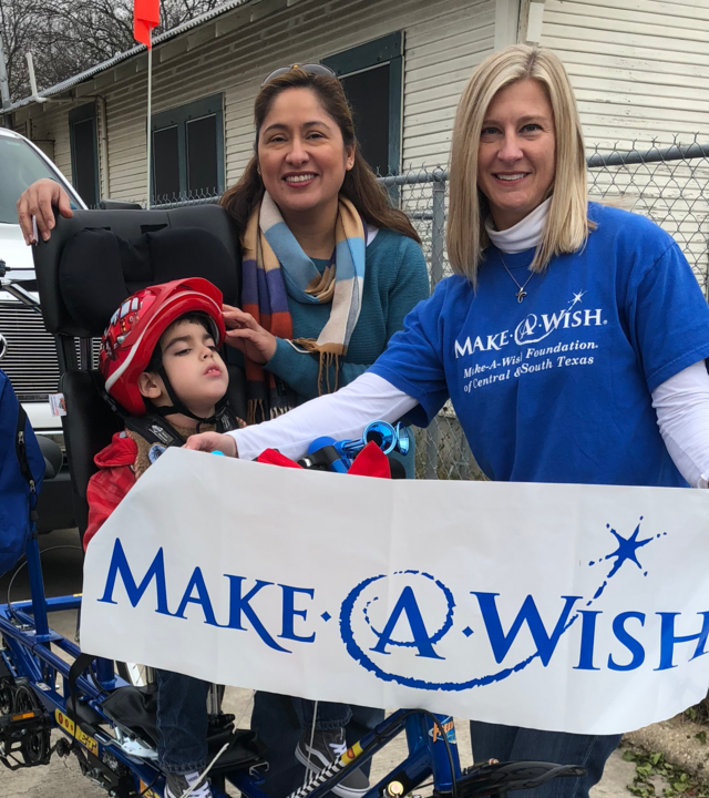 Sarah with wish kid and mom and brand new bike.