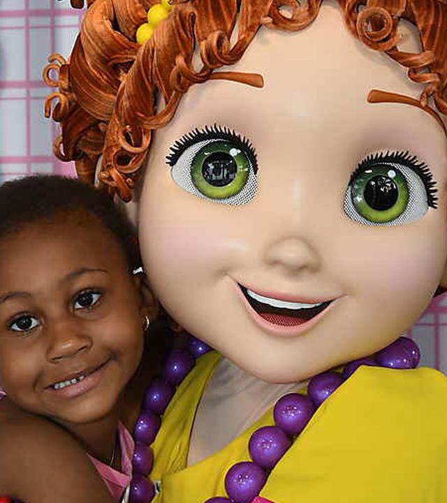 Wish child Taylor hugs a theme park character