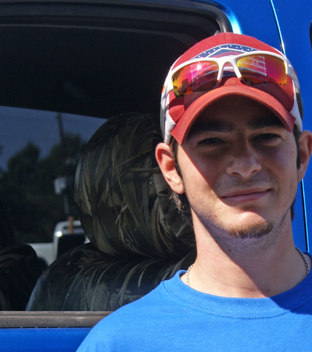 Michael smiles in front of his new truck.