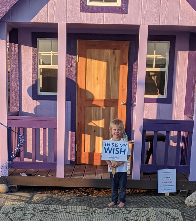 Amillia in front of her playhouse