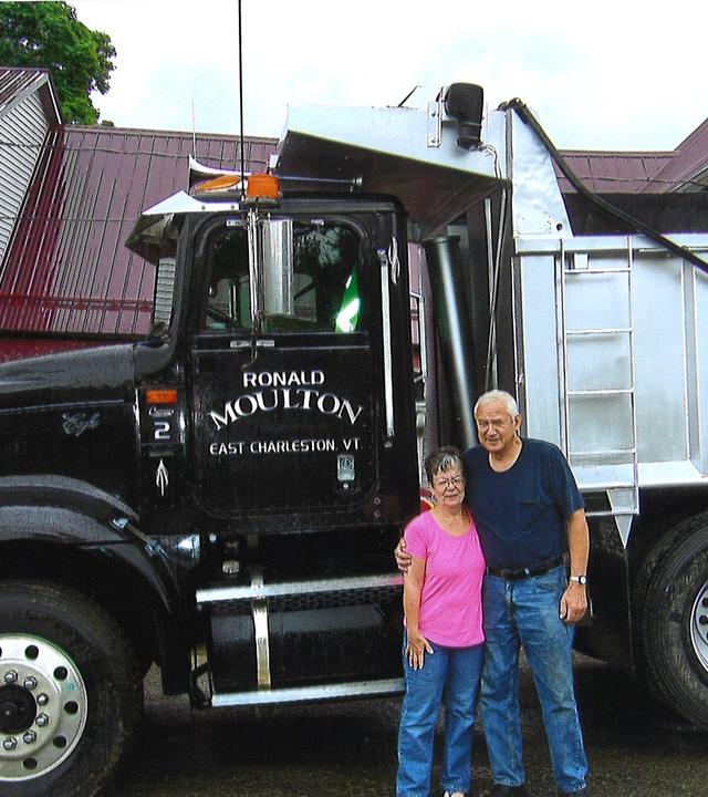 Judy and Ron Moulton stand in front of his commercial truck