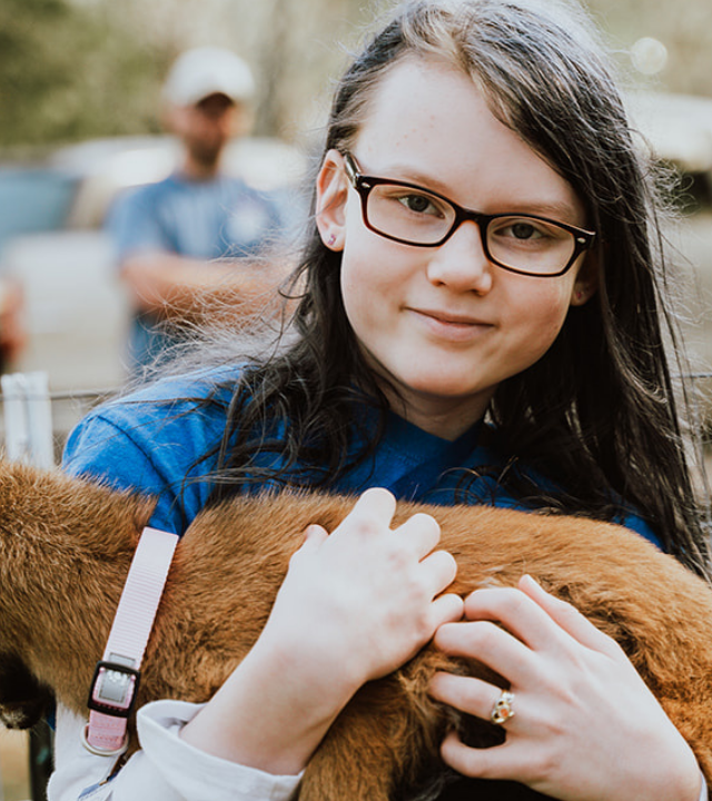 Madison hugs her one of her new pet goats, Mina