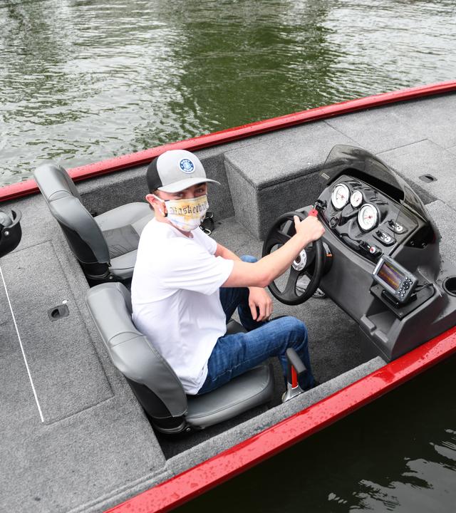 Noah sits at the helm of his new bass fishing boat