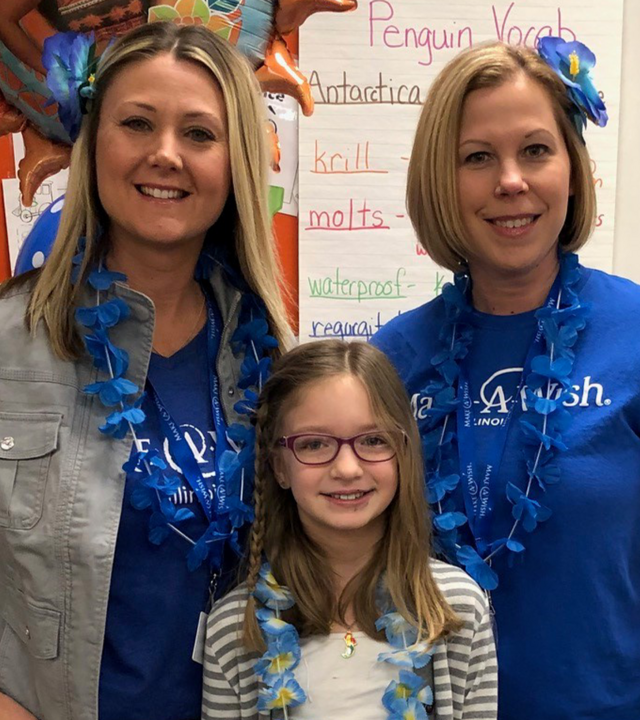 Make-A-Wish volunteers smile with wish child