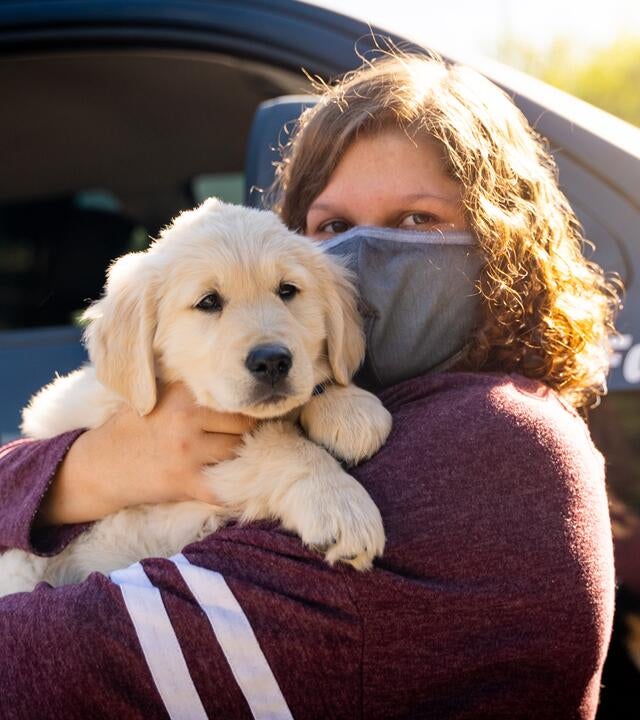 Lauren's smiles with puppy Casper