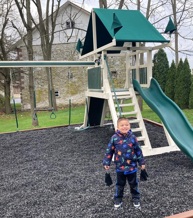 Sebastian standing with his playset 