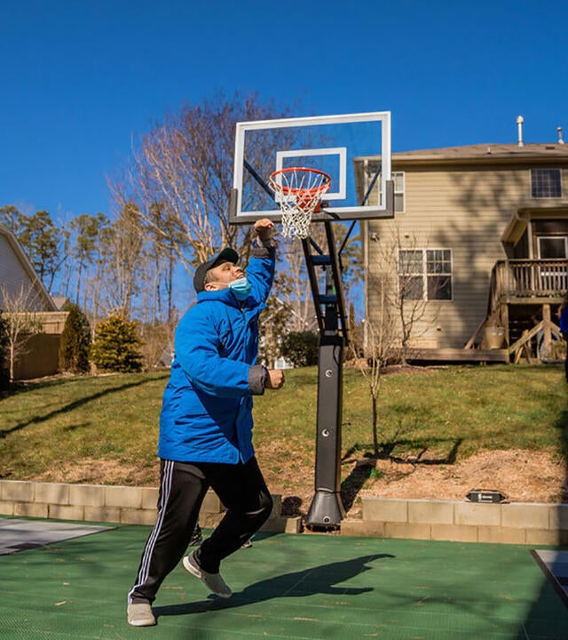 Wish kid Luke playing basketball on his sport court