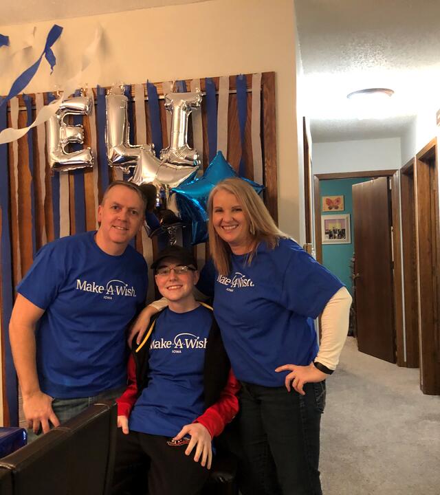 Elijah and his family smile for the camera the day his wish is granted.