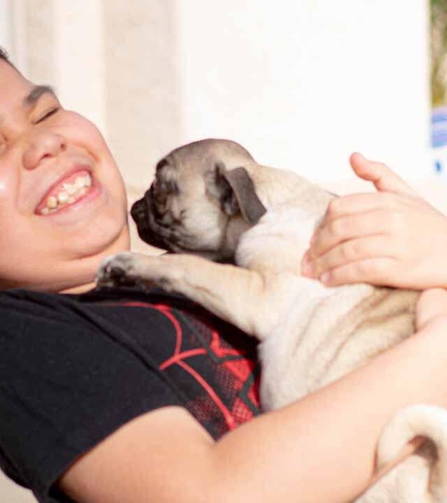 Jean could not contain his happiness meeting his pug puppy