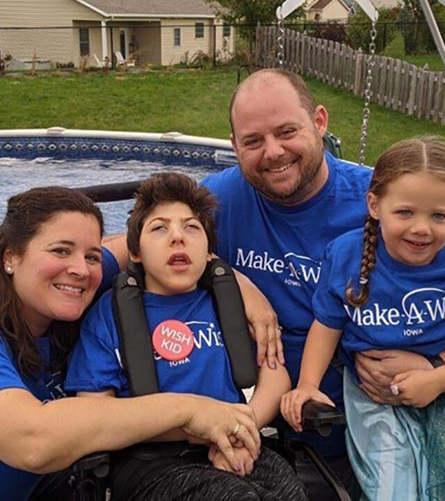 Owen and his family take a picture in front of their new above ground pool.