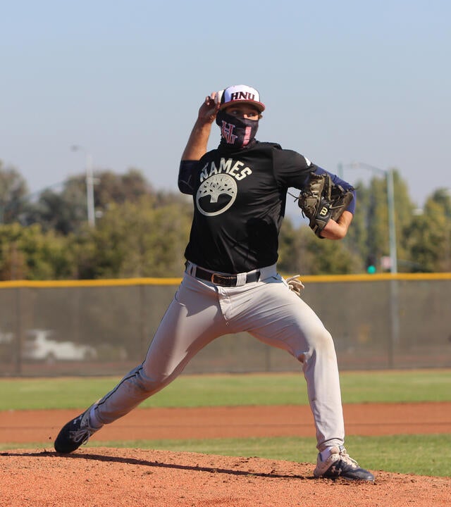 Jack Delmore pitches a baseball