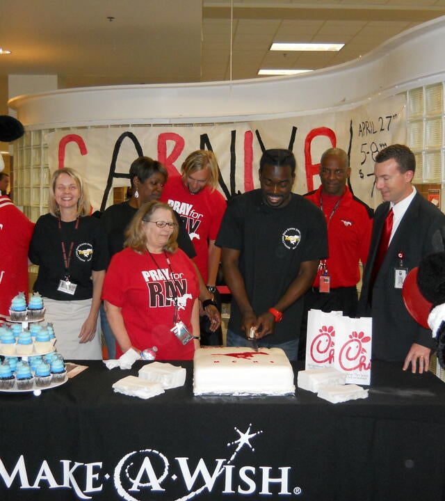 Wish kid Rashawn with the meal service team