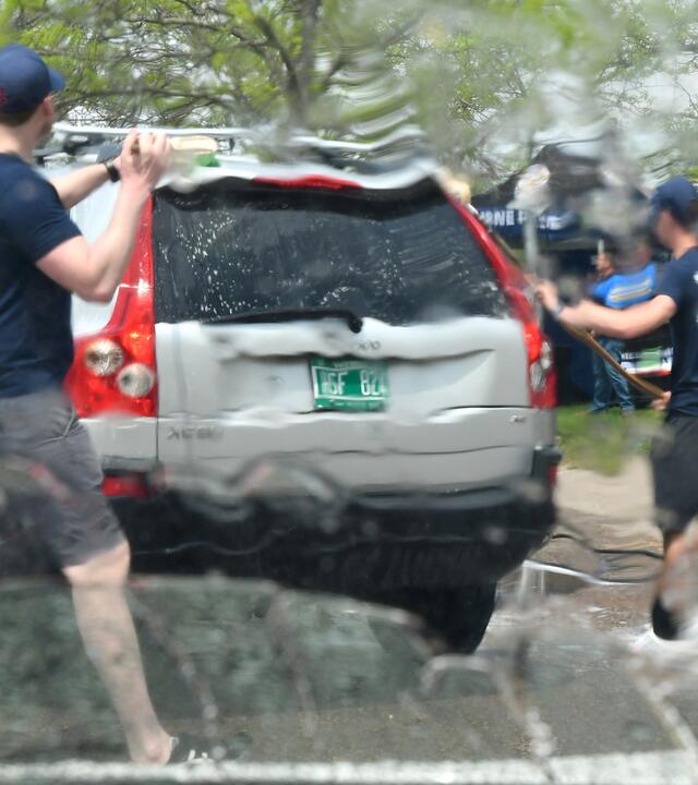 Two men wash a station wagon