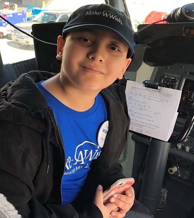 wish kid in pilot seat on a plane