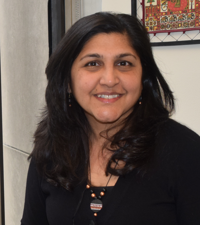 Dr. Peddinti smiling in her office
