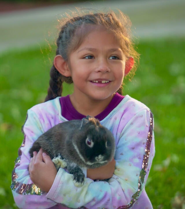Annie posing for a photo with a new furry friend.
