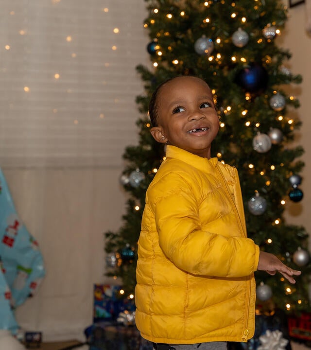 Aayden explores his gifts under his Christmas tree!