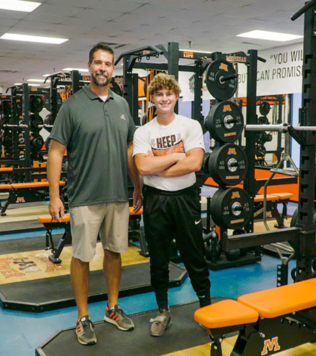 Scott in new weight room with his coach 