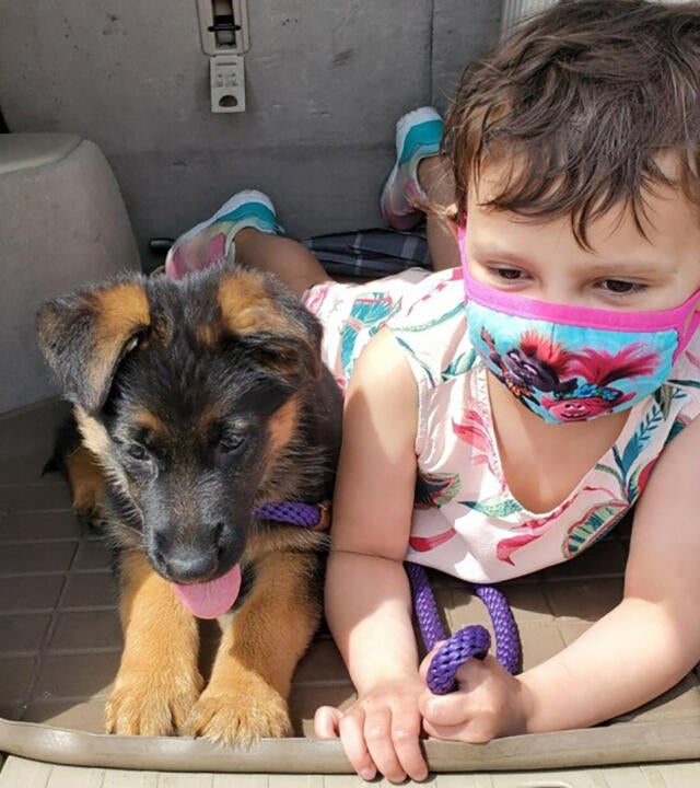 Wish kid Berkeley with her German Shepherd puppy