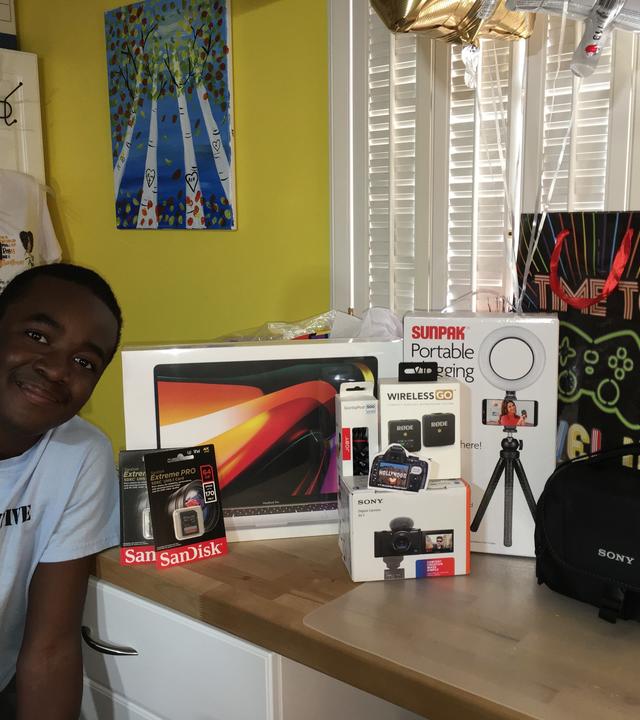Renard, smiling, in front of new gaming items