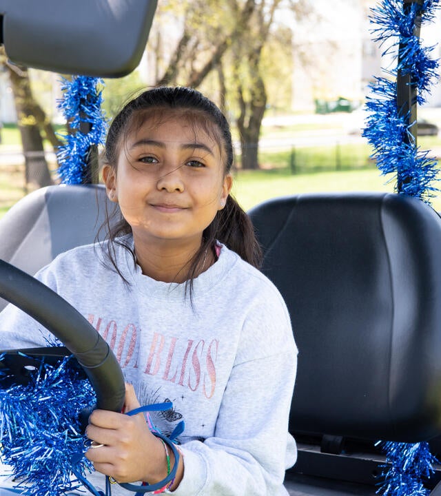 Sophia in her golf cart