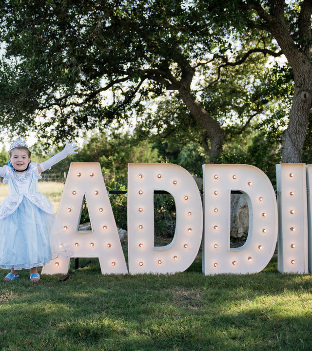 Princess Addie in front of a big sign of her name.