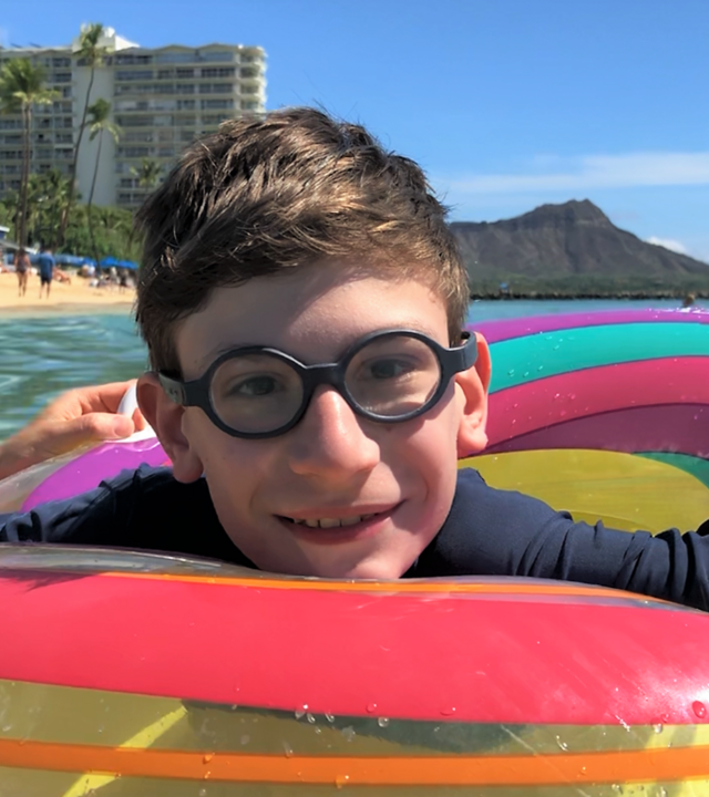 Nikita smiling and floating in an innertube