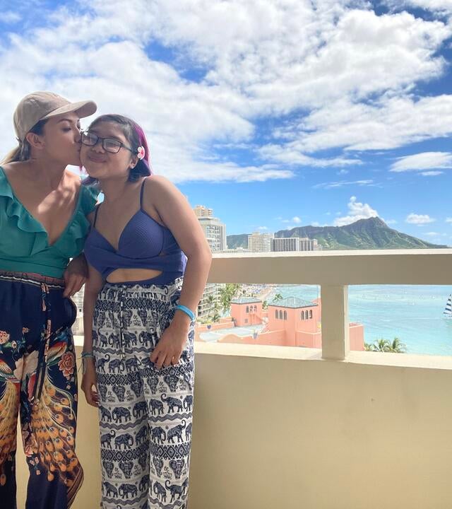 wish kid Abby and their mom on the balcony of their hotel in Hawaii