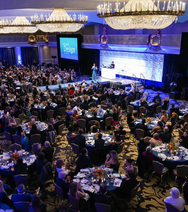 Guests enjoy dinner at tables in the ballroom at the Fairmont