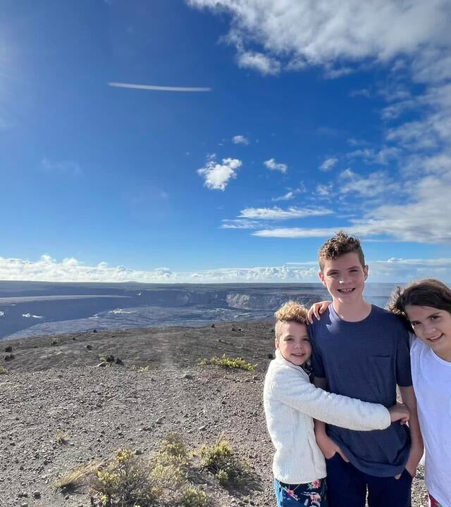 Wish kid Harrison with his siblings on the top of a volcano