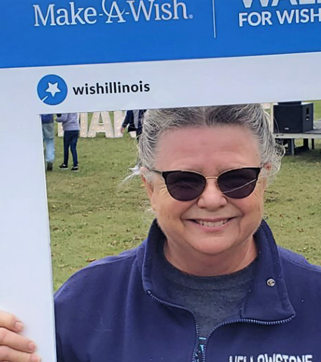 Volunteer Debi smiling through a picture frame