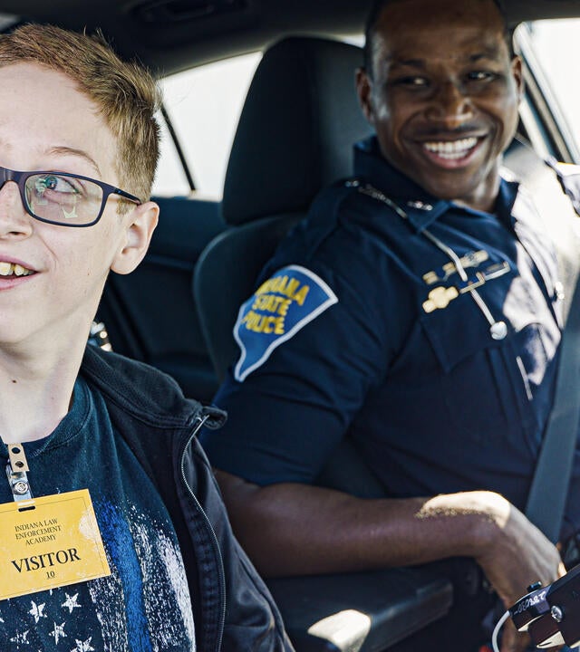 Wish kid Johnny in police car with Indiana State Police