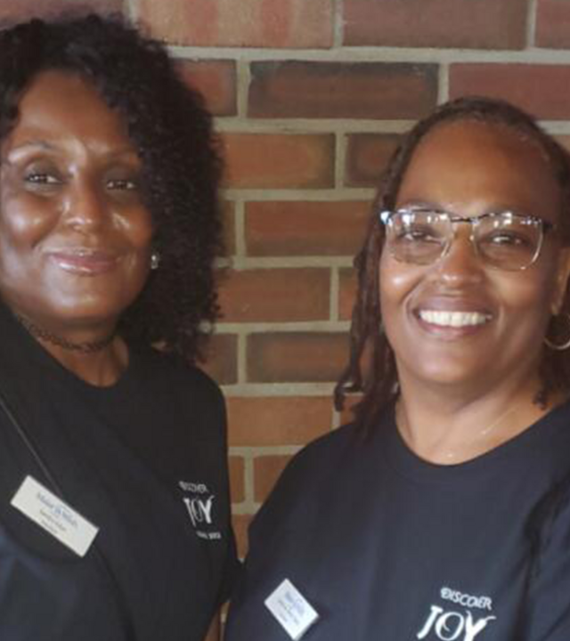 Two smiling volunteers