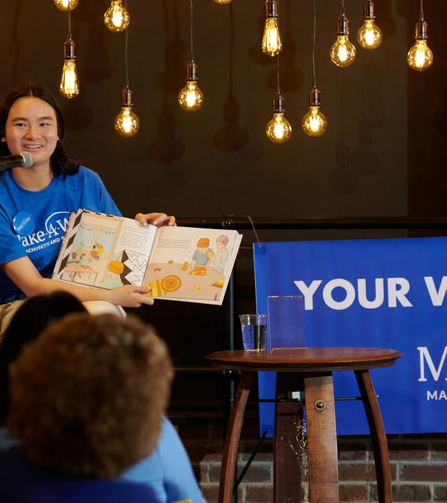 Wish kid Amelia on stage at her book launch party