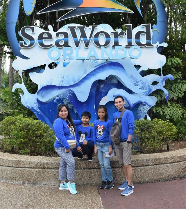 Jeshua and family enjoy his wish at SeaWorld. They wear Make-A-Wish blue to mark the occasion. Jeshua has battled leukemia and this trip has offered a bright spot in his medical journey.
