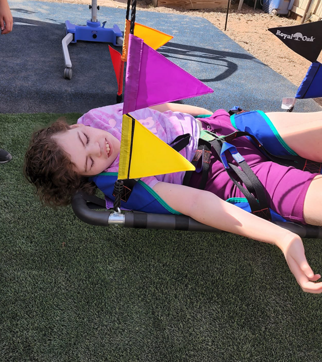 Lily loves her new adaptive swing where she can lay down and sway.