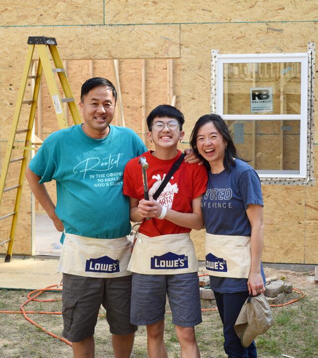 Manny pictured center with his parents on the construction site