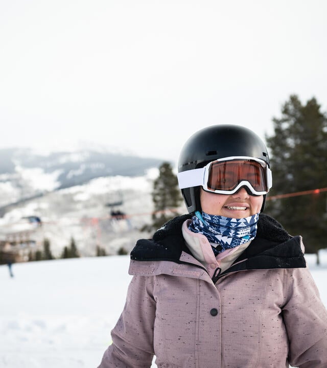 Wish kid Antonia dressed in ski gear on a snowy mountain slope