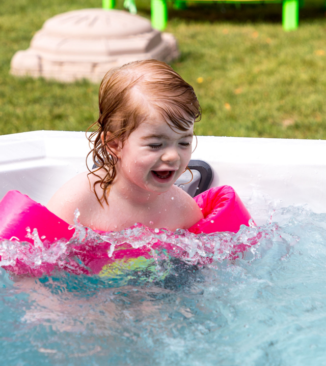 Spencer with floaties in her hot tub