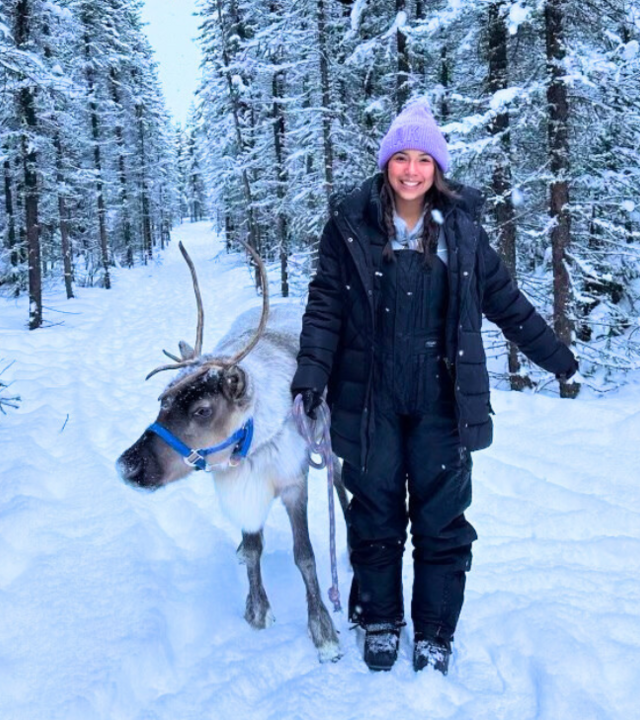 Wish kid Theresa with reindeer in snow