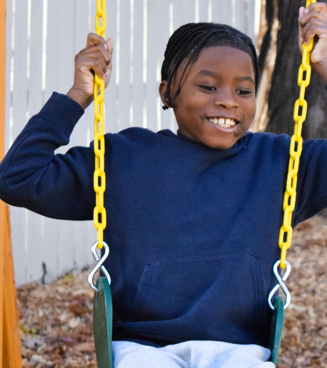 Photo of Davaughn on a swing set