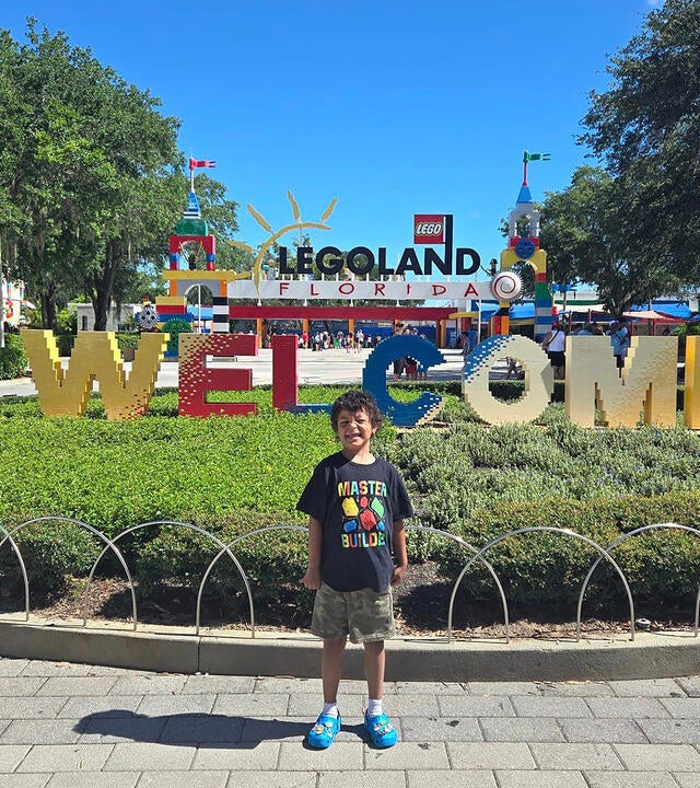Wish kid standing outside main entrance to Legoland