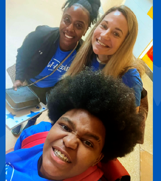 three people smiling at the camera
