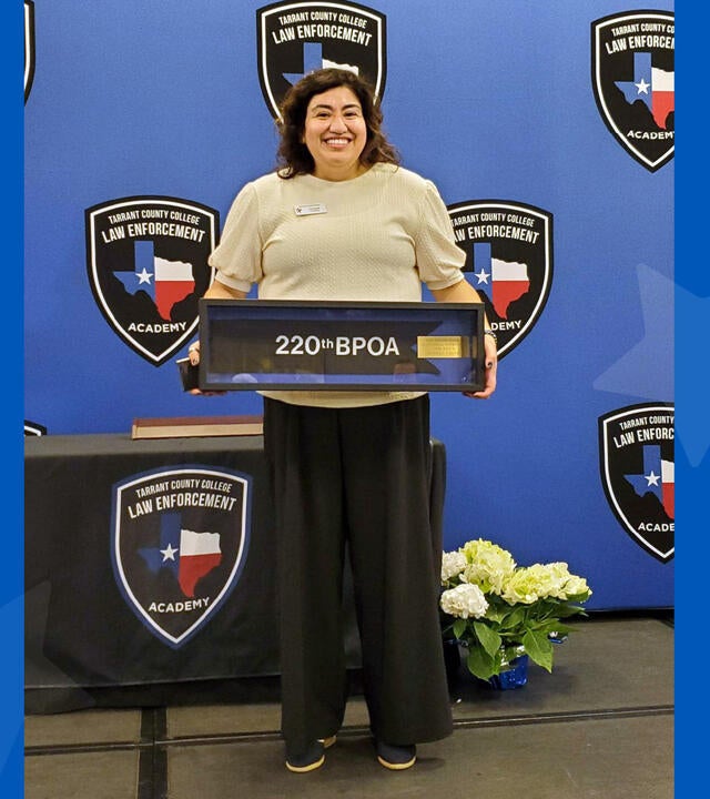 woman smiling behind a podium