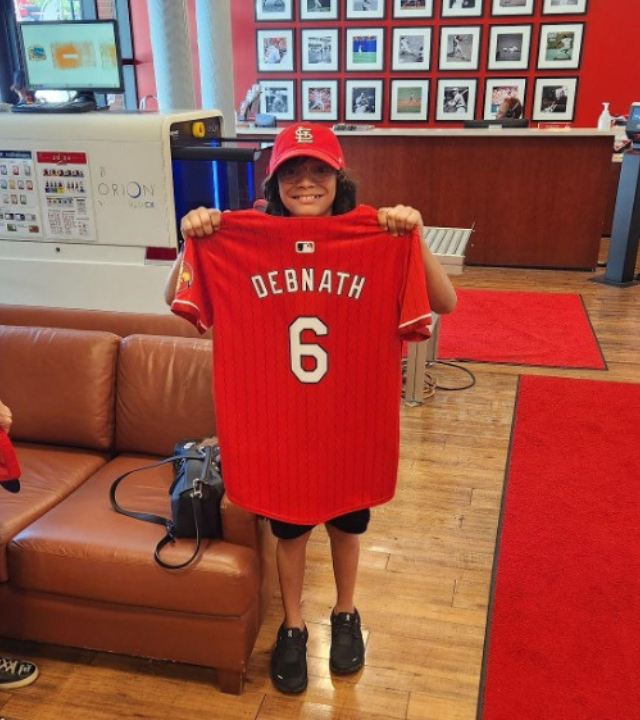 Sid holding Cardinal's jersey