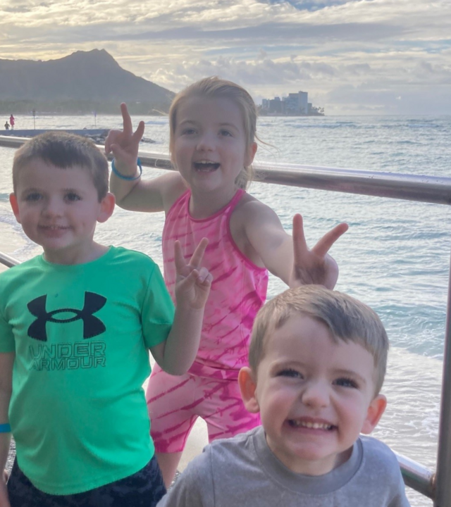 Wish kid Aileen with her brothers, posing at sunset in Hawaii