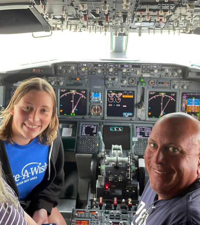 Briana and family in the cockpit of an airplane