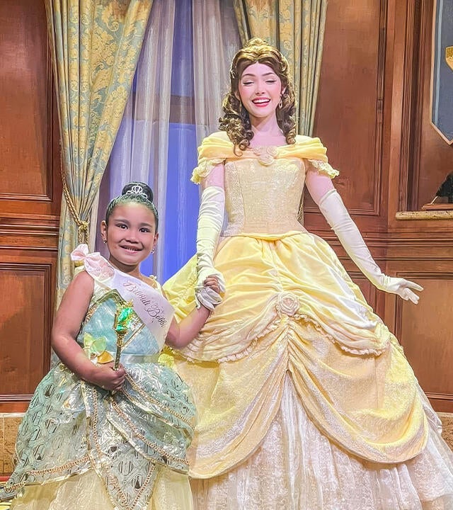 Cassandra takes a picture with Princess Belle