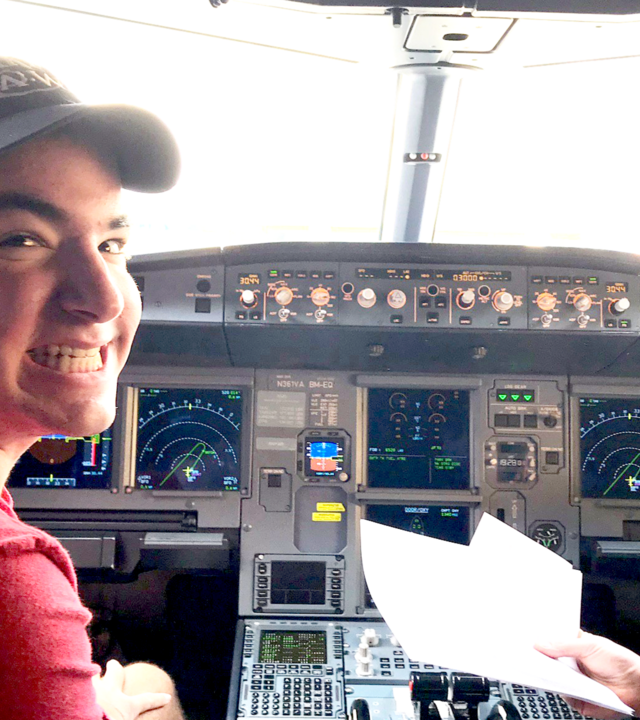 Max sitting in the cockpit of the plane on his way to Los Angeles in 2017.